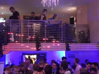 Crowd below the balcony DJ booth